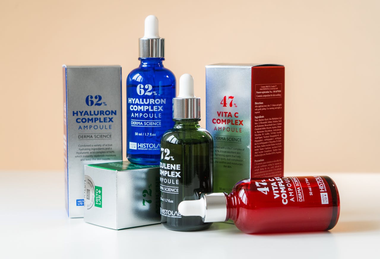 Close-up of ampoules and packaging for skincare products, emphasizing vibrant design.